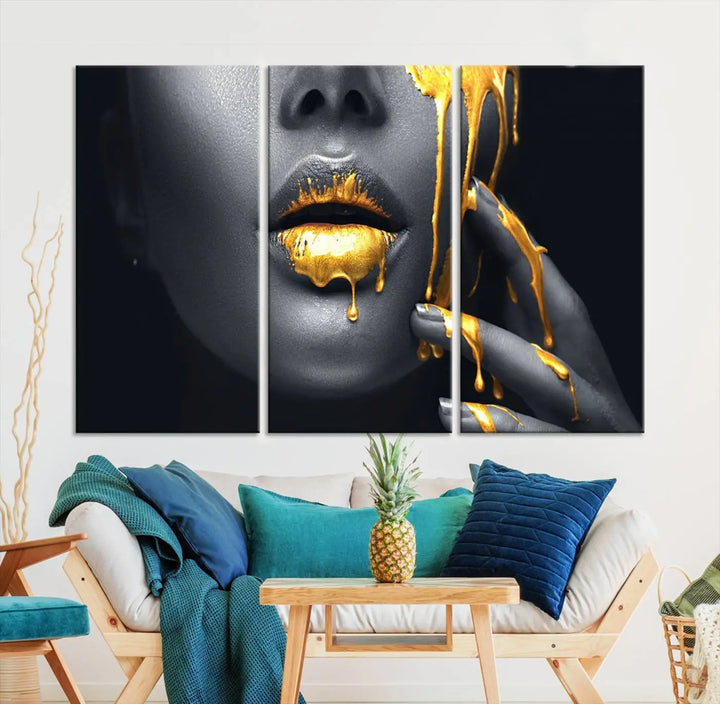 The modern living room features a striking triptych called the "Gold Glitter Lips Fashion Photography Wall Art Makeup" canvas print.