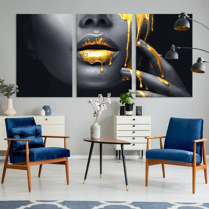 The modern living room features a striking triptych called the "Gold Glitter Lips Fashion Photography Wall Art Makeup" canvas print.