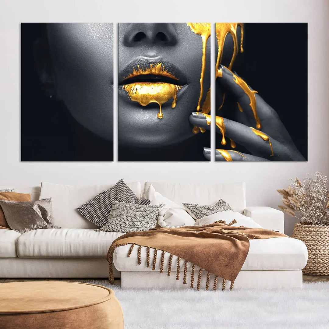 The modern living room features a striking triptych called the "Gold Glitter Lips Fashion Photography Wall Art Makeup" canvas print.