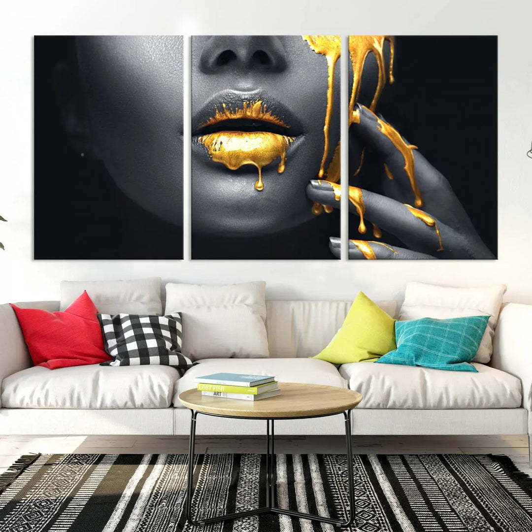 The modern living room features a striking triptych called the "Gold Glitter Lips Fashion Photography Wall Art Makeup" canvas print.