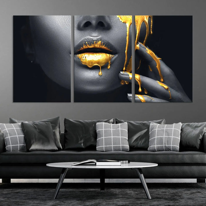 The modern living room features a striking triptych called the "Gold Glitter Lips Fashion Photography Wall Art Makeup" canvas print.