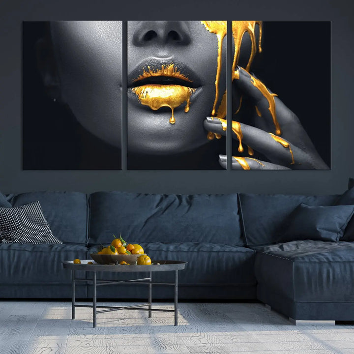 The modern living room features a striking triptych called the "Gold Glitter Lips Fashion Photography Wall Art Makeup" canvas print.