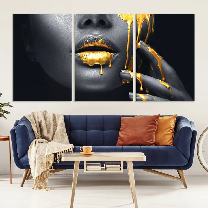 The modern living room features a striking triptych called the "Gold Glitter Lips Fashion Photography Wall Art Makeup" canvas print.