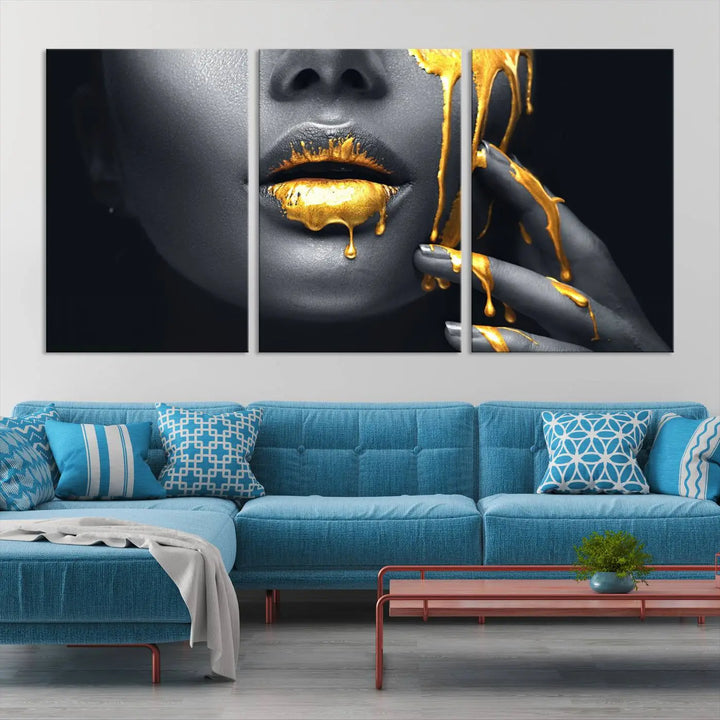 The modern living room features a striking triptych called the "Gold Glitter Lips Fashion Photography Wall Art Makeup" canvas print.