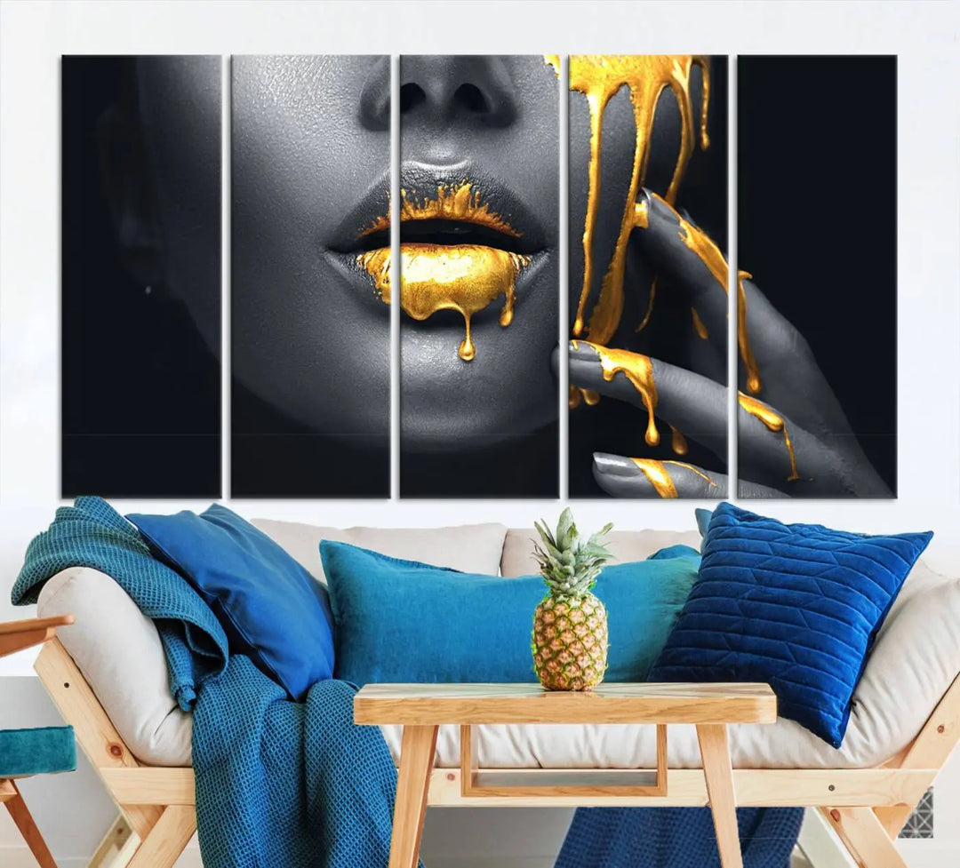 The modern living room features a striking triptych called the "Gold Glitter Lips Fashion Photography Wall Art Makeup" canvas print.