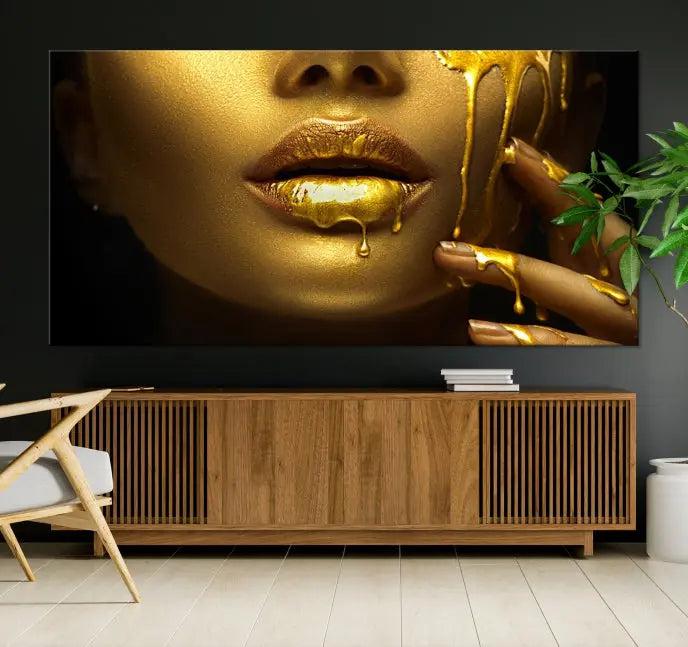 The Gold and Women Wall Art Canvas Print, with its exquisite golden depiction of a face and hand, elegantly adorns the space, bringing luxurious gold accents to this stylish living room.