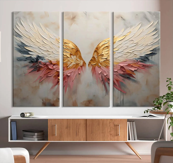 The "Golden Angel Wings Wall Art Canvas Print – Stunning Abstract Winged Art for Elegant Home Decor – Ready to Hang" adorns the dark wall above, showcasing an elegant triptych with abstract gold and pink hues.