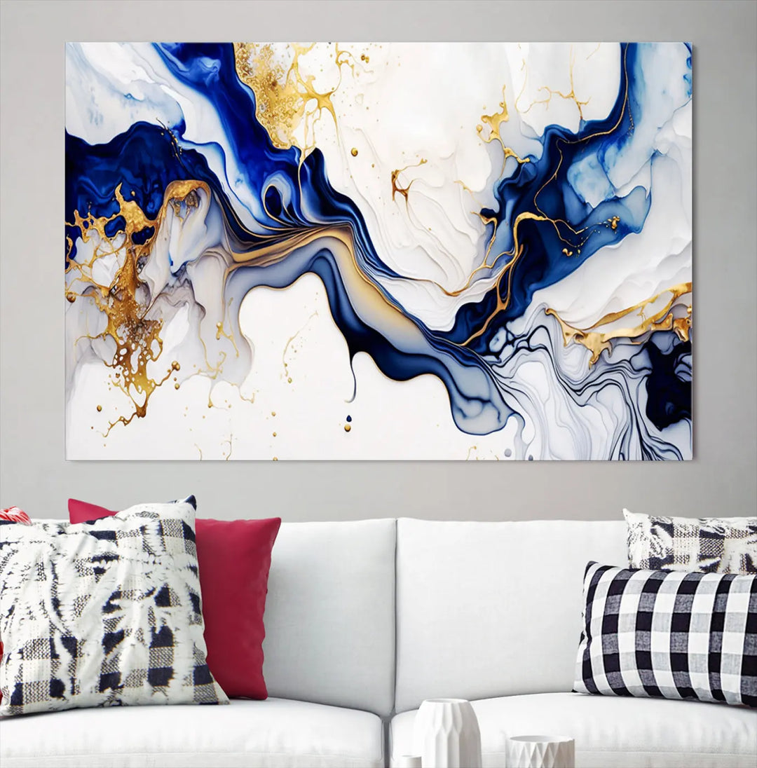 Enhance your modern home decor with the "Golden Cascades on Midnight Blue – Abstract Flowing Elegance" wall art canvas. This stunning piece features dynamic blue, gold, and white patterns. The triptych design comes framed and ready to hang, infusing any space with artistic expression.