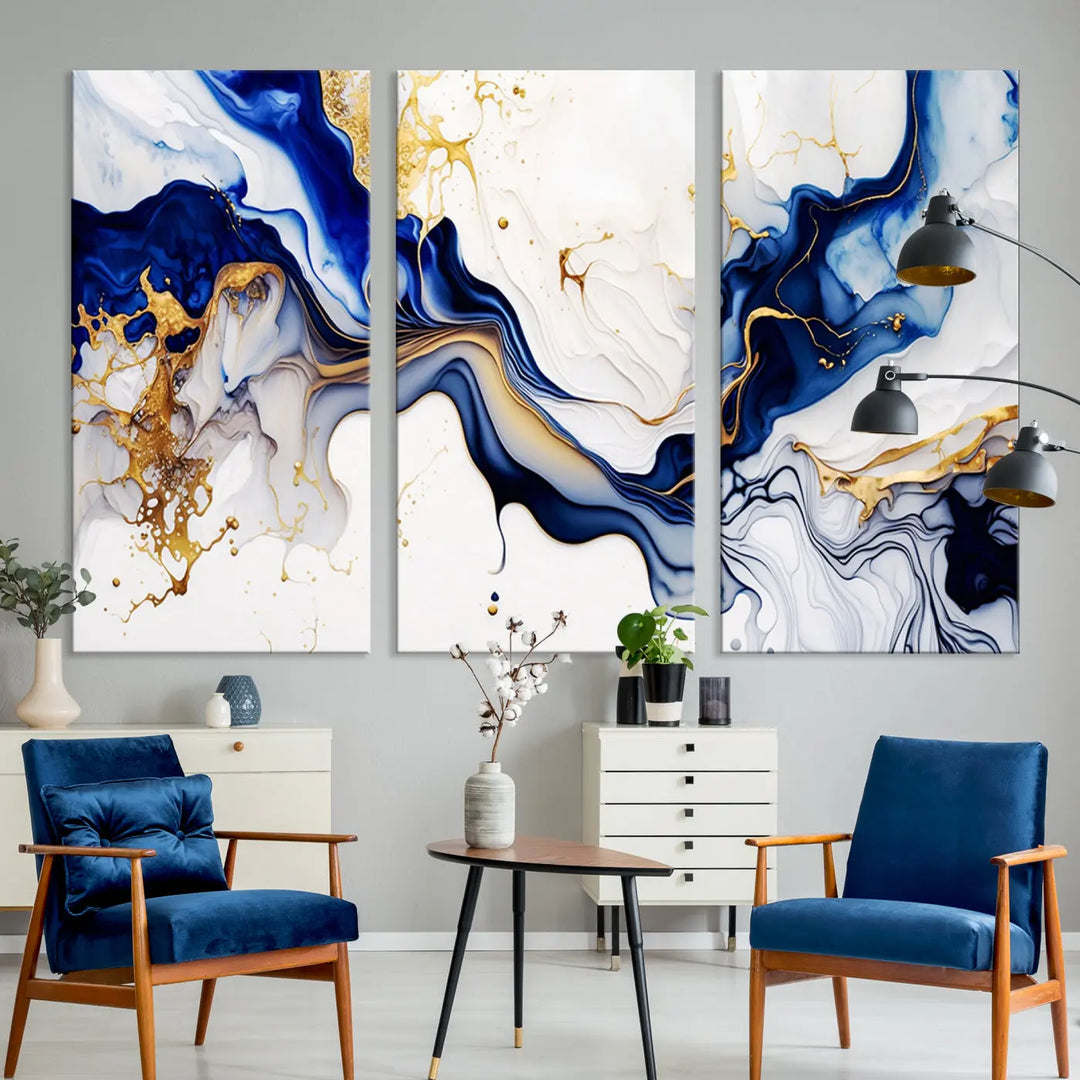 Enhance your modern home decor with the "Golden Cascades on Midnight Blue – Abstract Flowing Elegance" wall art canvas. This stunning piece features dynamic blue, gold, and white patterns. The triptych design comes framed and ready to hang, infusing any space with artistic expression.