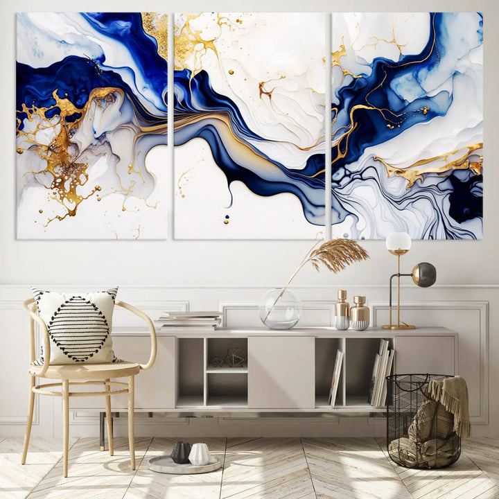 Enhance your modern home decor with the "Golden Cascades on Midnight Blue – Abstract Flowing Elegance" wall art canvas. This stunning piece features dynamic blue, gold, and white patterns. The triptych design comes framed and ready to hang, infusing any space with artistic expression.