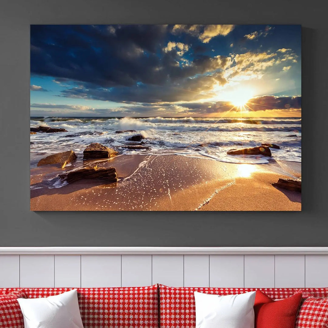 The cozy living room is enhanced by the Golden Hour Beach Sunset Canvas Triptych, featuring ocean waves and rocks.