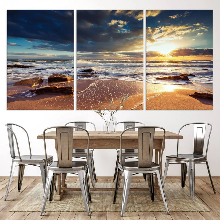 The cozy living room is enhanced by the Golden Hour Beach Sunset Canvas Triptych, featuring ocean waves and rocks.