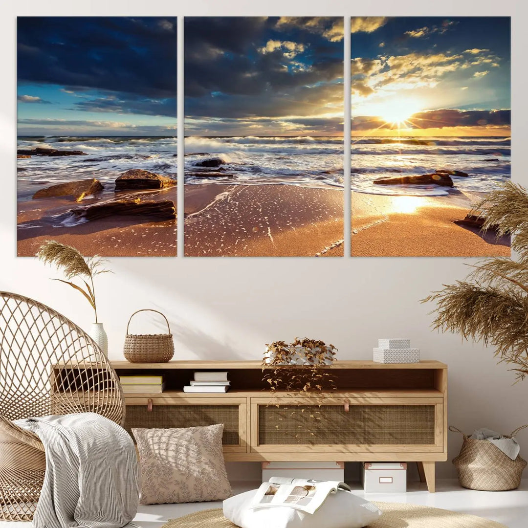 The cozy living room is enhanced by the Golden Hour Beach Sunset Canvas Triptych, featuring ocean waves and rocks.