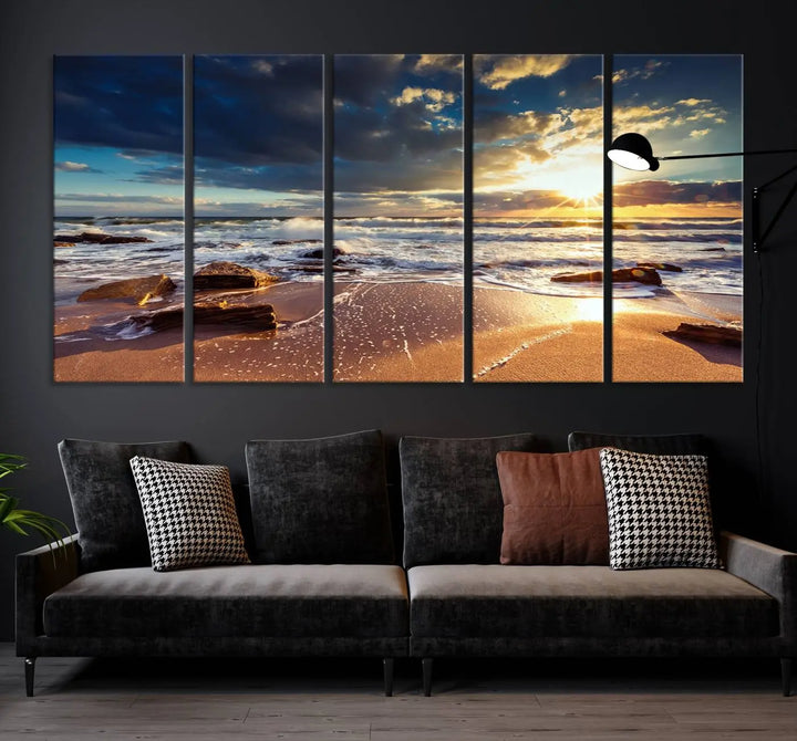 The cozy living room is enhanced by the Golden Hour Beach Sunset Canvas Triptych, featuring ocean waves and rocks.