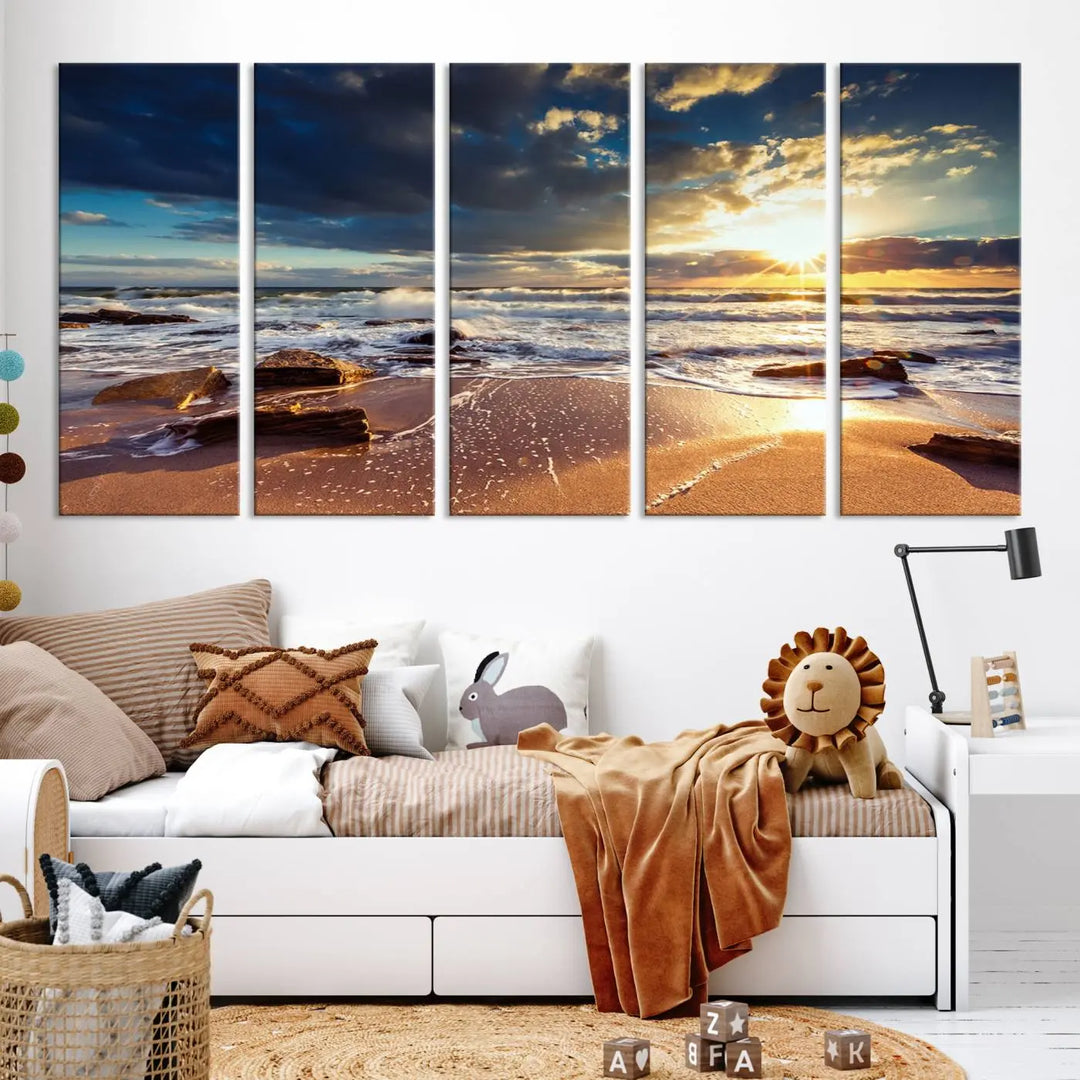 The cozy living room is enhanced by the Golden Hour Beach Sunset Canvas Triptych, featuring ocean waves and rocks.