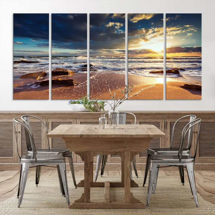 The cozy living room is enhanced by the Golden Hour Beach Sunset Canvas Triptych, featuring ocean waves and rocks.