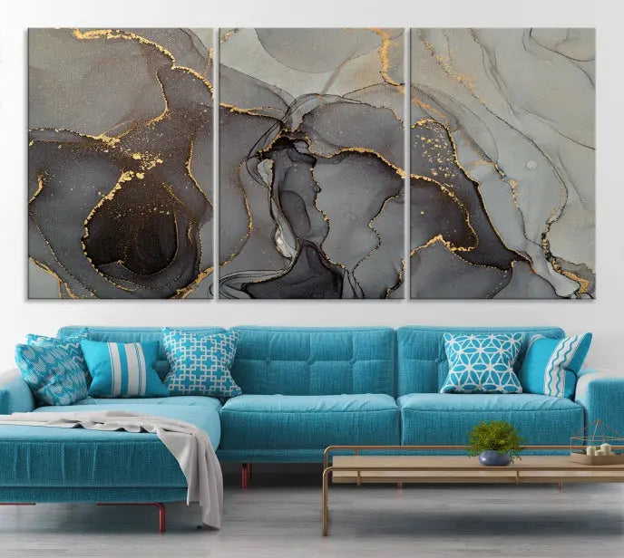 The Gray Marble Fluid Effect Wall Art Abstract Canvas Wall Art Print is a museum-quality canvas featuring triptych abstract art with swirling gray and gold patterns. Complete with a UV-protective coating, this piece of artwork arrives ready to hang, effortlessly elevating your living space.