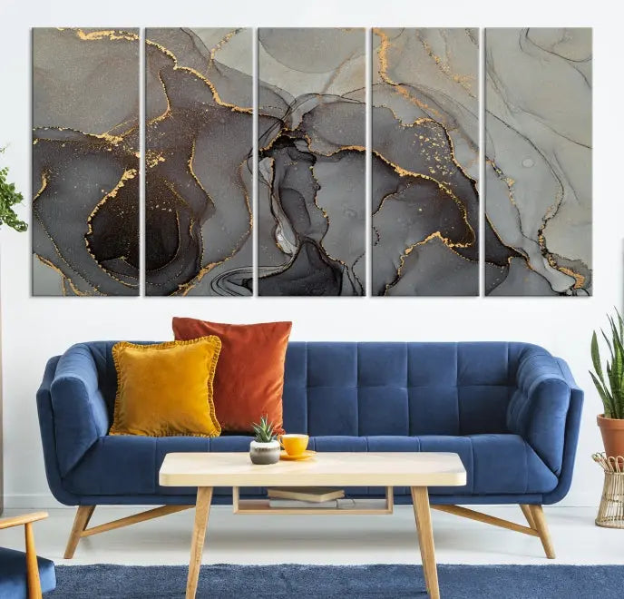 The Gray Marble Fluid Effect Wall Art Abstract Canvas Wall Art Print is a museum-quality canvas featuring triptych abstract art with swirling gray and gold patterns. Complete with a UV-protective coating, this piece of artwork arrives ready to hang, effortlessly elevating your living space.