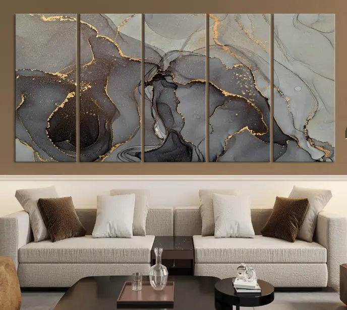 The Gray Marble Fluid Effect Wall Art Abstract Canvas Wall Art Print is a museum-quality canvas featuring triptych abstract art with swirling gray and gold patterns. Complete with a UV-protective coating, this piece of artwork arrives ready to hang, effortlessly elevating your living space.