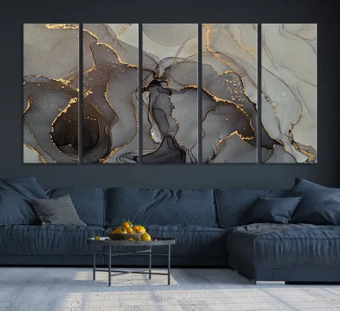 The Gray Marble Fluid Effect Wall Art Abstract Canvas Wall Art Print is a museum-quality canvas featuring triptych abstract art with swirling gray and gold patterns. Complete with a UV-protective coating, this piece of artwork arrives ready to hang, effortlessly elevating your living space.