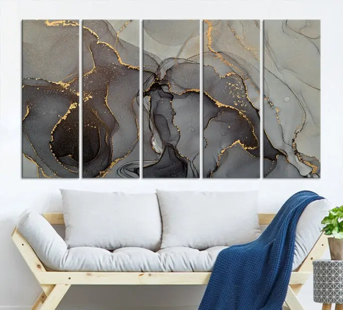 The Gray Marble Fluid Effect Wall Art Abstract Canvas Wall Art Print is a museum-quality canvas featuring triptych abstract art with swirling gray and gold patterns. Complete with a UV-protective coating, this piece of artwork arrives ready to hang, effortlessly elevating your living space.