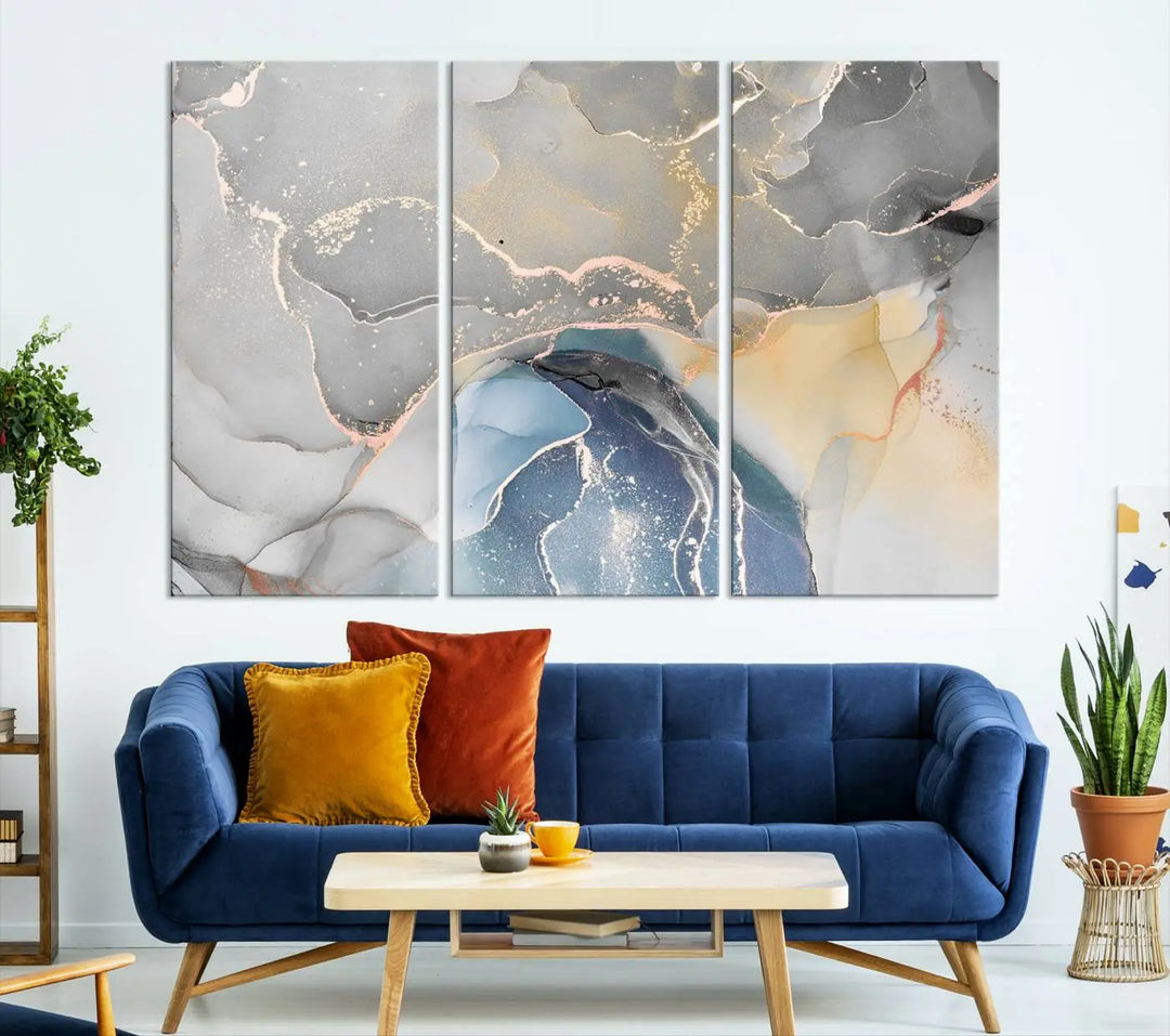 The Gray Marble Fluid Effect Wall Art Abstract Canvas Wall Art Print features elegant gold, blue, and gray hues. Crafted on museum-quality canvas, it includes a UV-protective coating for enduring vibrance. Enjoy the added benefit of free shipping.