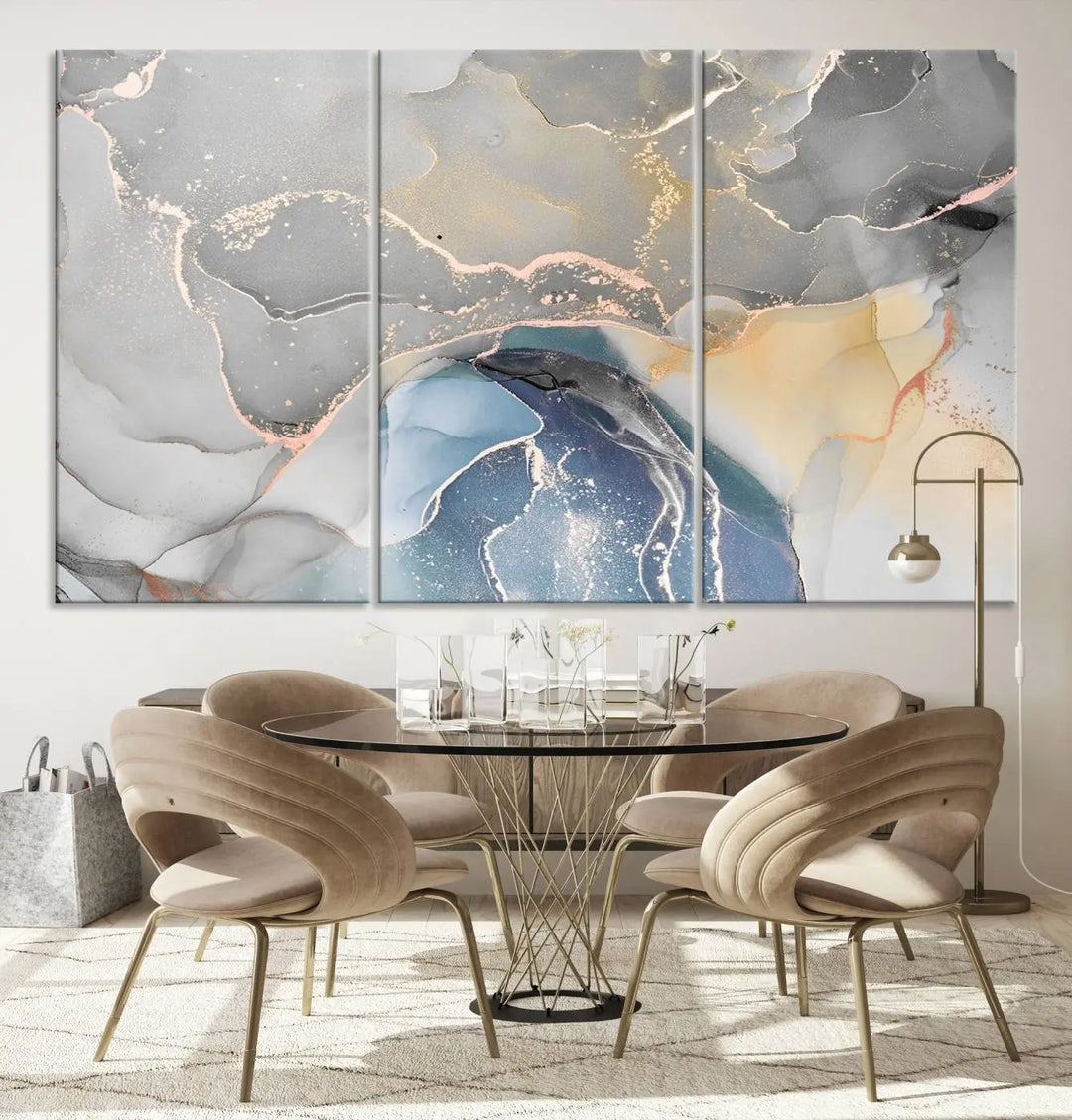 The Gray Marble Fluid Effect Wall Art Abstract Canvas Wall Art Print features elegant gold, blue, and gray hues. Crafted on museum-quality canvas, it includes a UV-protective coating for enduring vibrance. Enjoy the added benefit of free shipping.