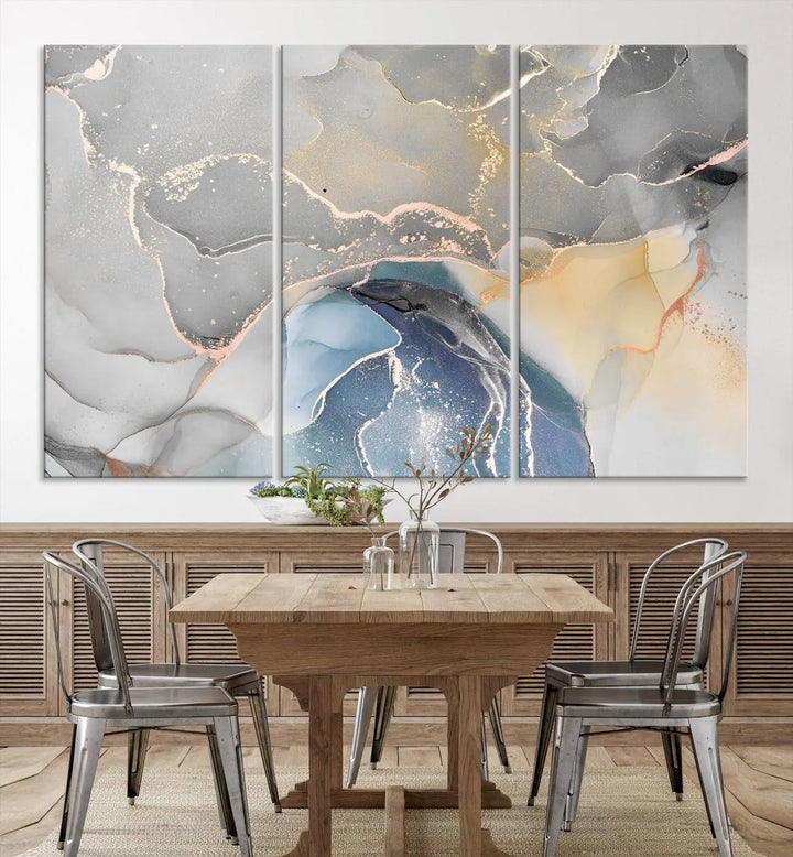 The Gray Marble Fluid Effect Wall Art Abstract Canvas Wall Art Print features elegant gold, blue, and gray hues. Crafted on museum-quality canvas, it includes a UV-protective coating for enduring vibrance. Enjoy the added benefit of free shipping.