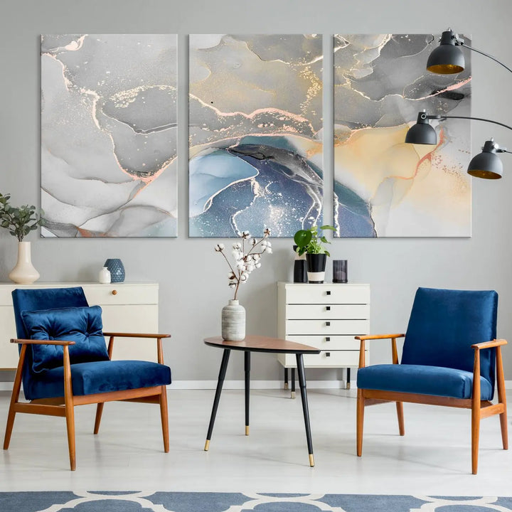 The Gray Marble Fluid Effect Wall Art Abstract Canvas Wall Art Print features elegant gold, blue, and gray hues. Crafted on museum-quality canvas, it includes a UV-protective coating for enduring vibrance. Enjoy the added benefit of free shipping.