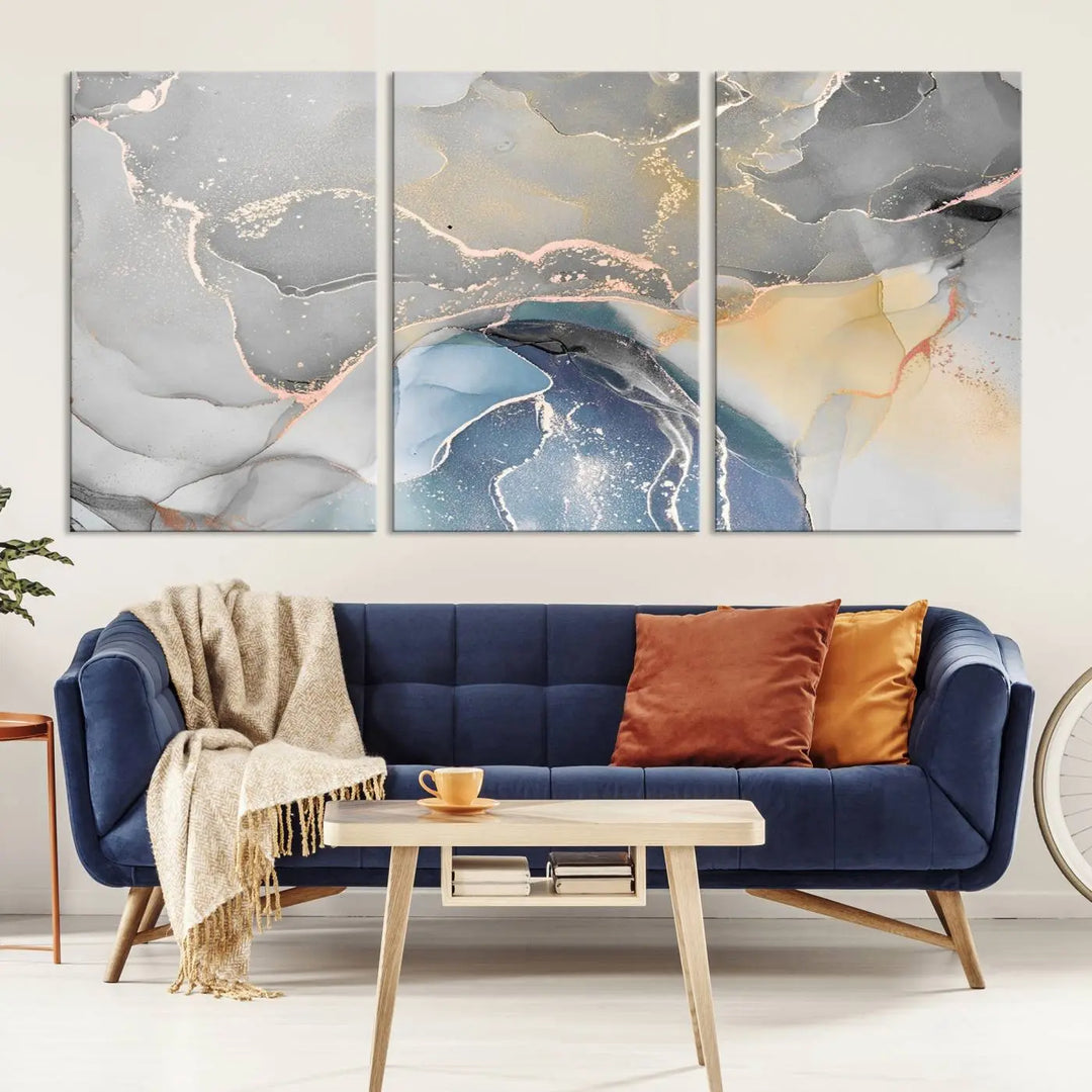 The Gray Marble Fluid Effect Wall Art Abstract Canvas Wall Art Print features elegant gold, blue, and gray hues. Crafted on museum-quality canvas, it includes a UV-protective coating for enduring vibrance. Enjoy the added benefit of free shipping.