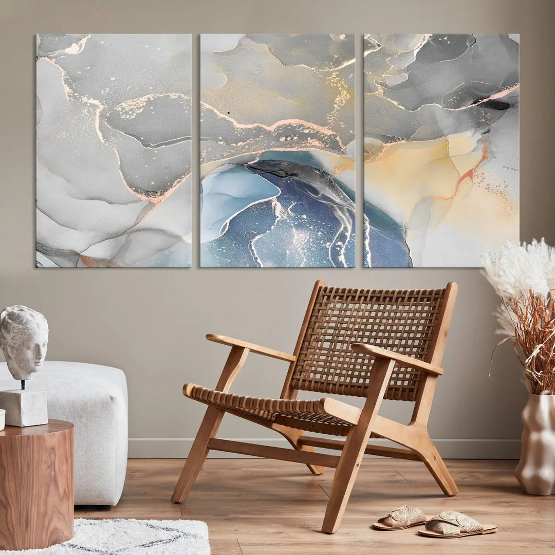 The Gray Marble Fluid Effect Wall Art Abstract Canvas Wall Art Print features elegant gold, blue, and gray hues. Crafted on museum-quality canvas, it includes a UV-protective coating for enduring vibrance. Enjoy the added benefit of free shipping.