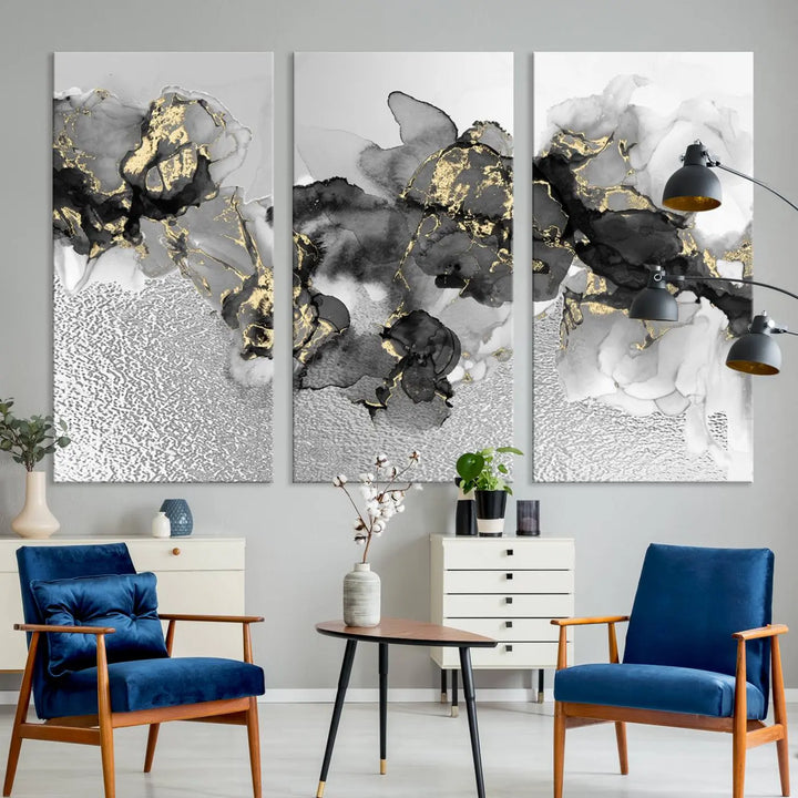 The Gray Marble Fluid Effect Wall Art Abstract Canvas Print, featuring black, white, and gold textured patterns, is crafted on museum-quality canvases and finished with a UV-protective coating. This piece adds sophistication to any space.