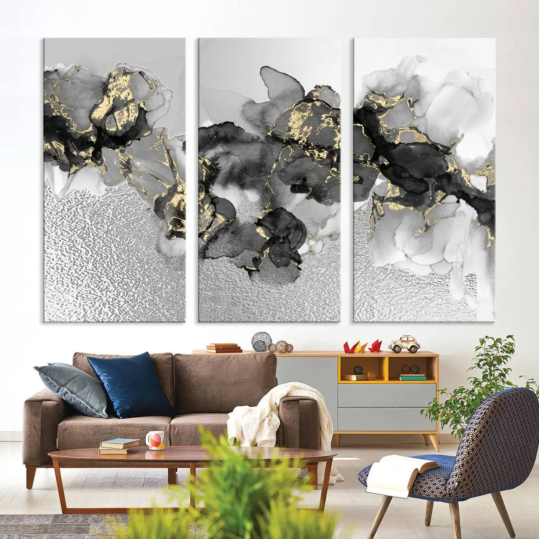 The Gray Marble Fluid Effect Wall Art Abstract Canvas Print, featuring black, white, and gold textured patterns, is crafted on museum-quality canvases and finished with a UV-protective coating. This piece adds sophistication to any space.