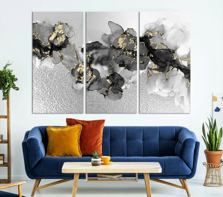 The Gray Marble Fluid Effect Wall Art Abstract Canvas Print, featuring black, white, and gold textured patterns, is crafted on museum-quality canvases and finished with a UV-protective coating. This piece adds sophistication to any space.