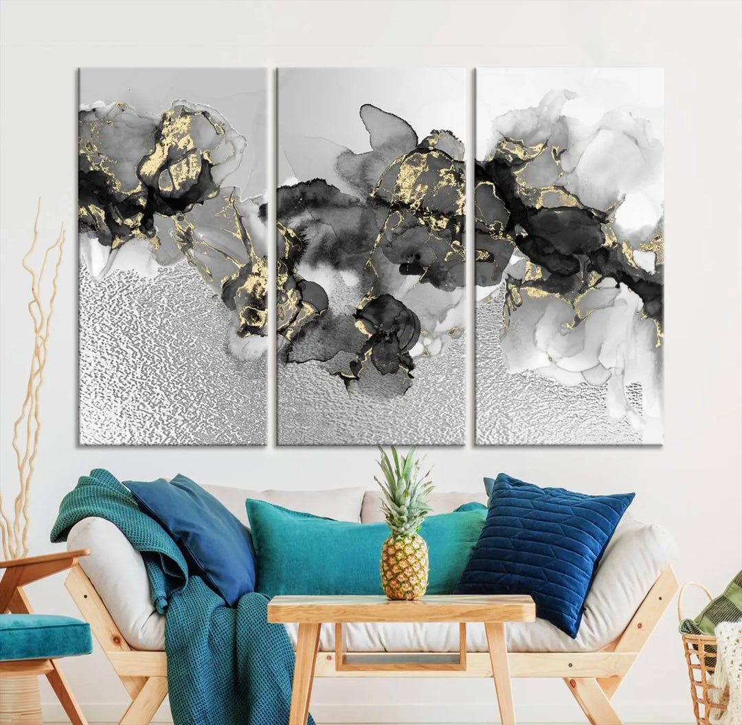 The Gray Marble Fluid Effect Wall Art Abstract Canvas Print, featuring black, white, and gold textured patterns, is crafted on museum-quality canvases and finished with a UV-protective coating. This piece adds sophistication to any space.