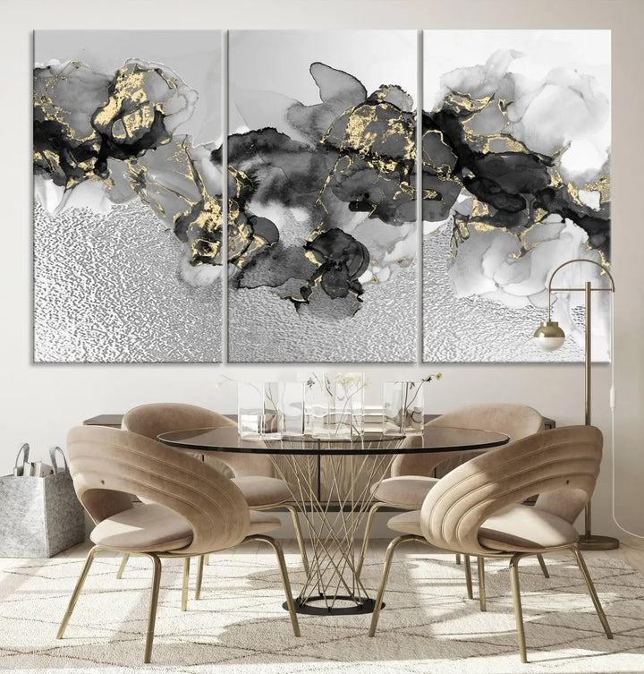 The Gray Marble Fluid Effect Wall Art Abstract Canvas Print, featuring black, white, and gold textured patterns, is crafted on museum-quality canvases and finished with a UV-protective coating. This piece adds sophistication to any space.