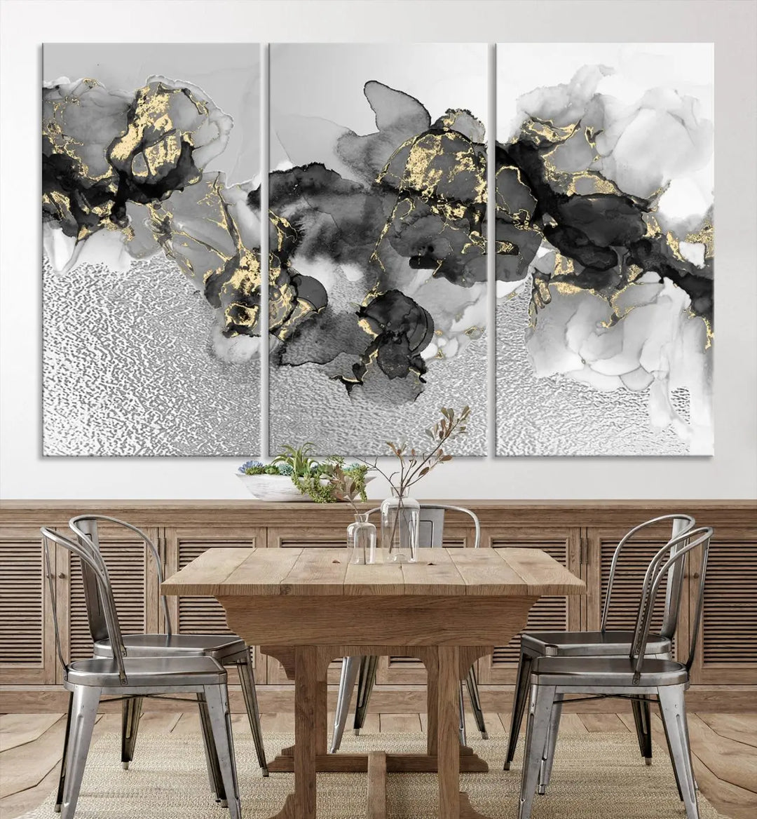 The Gray Marble Fluid Effect Wall Art Abstract Canvas Print, featuring black, white, and gold textured patterns, is crafted on museum-quality canvases and finished with a UV-protective coating. This piece adds sophistication to any space.