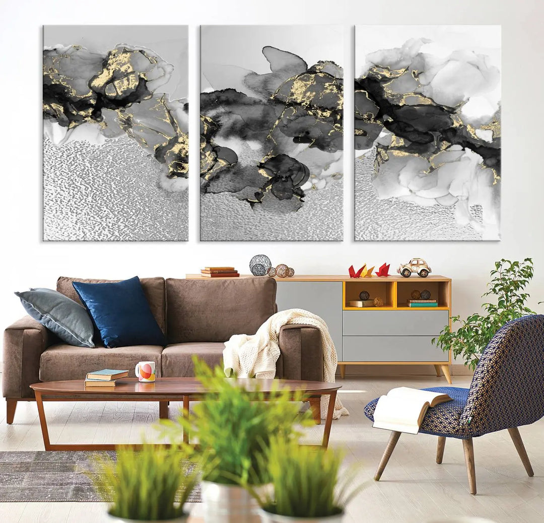 The Gray Marble Fluid Effect Wall Art Abstract Canvas Print, featuring black, white, and gold textured patterns, is crafted on museum-quality canvases and finished with a UV-protective coating. This piece adds sophistication to any space.