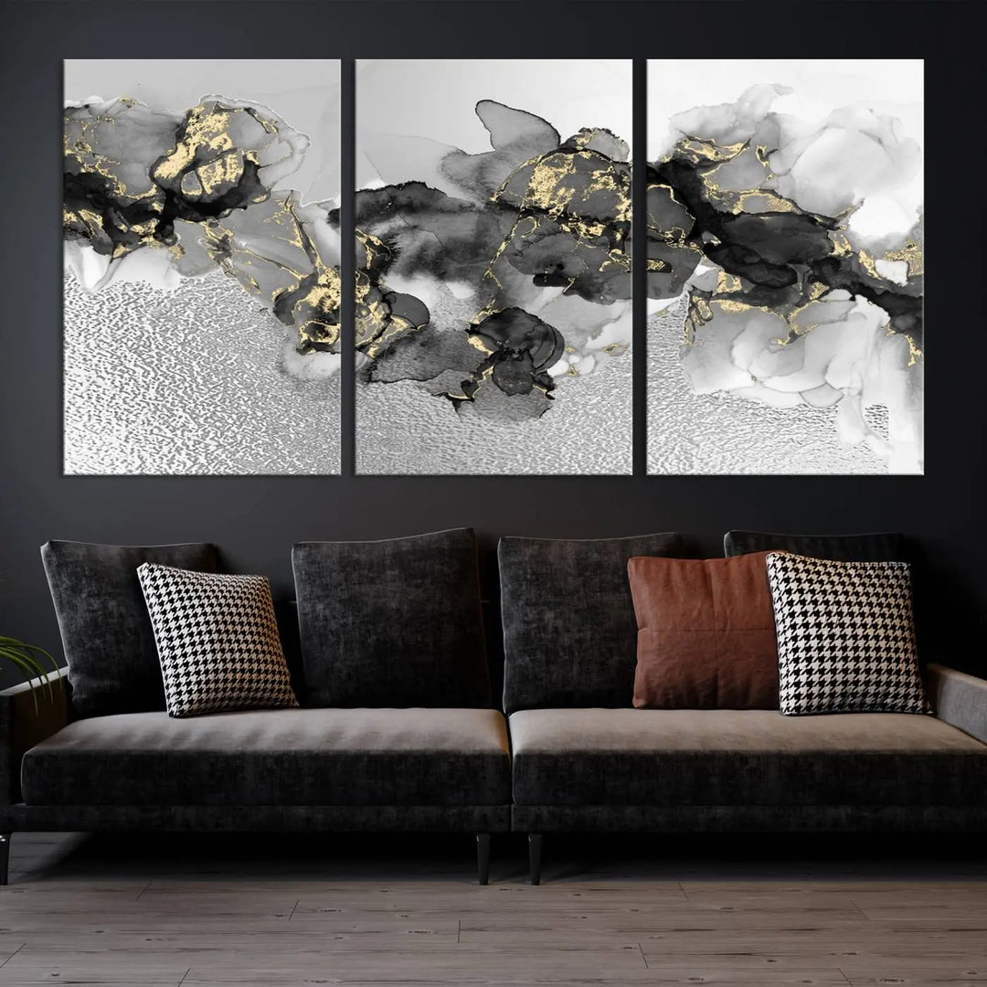 The Gray Marble Fluid Effect Wall Art Abstract Canvas Print, featuring black, white, and gold textured patterns, is crafted on museum-quality canvases and finished with a UV-protective coating. This piece adds sophistication to any space.