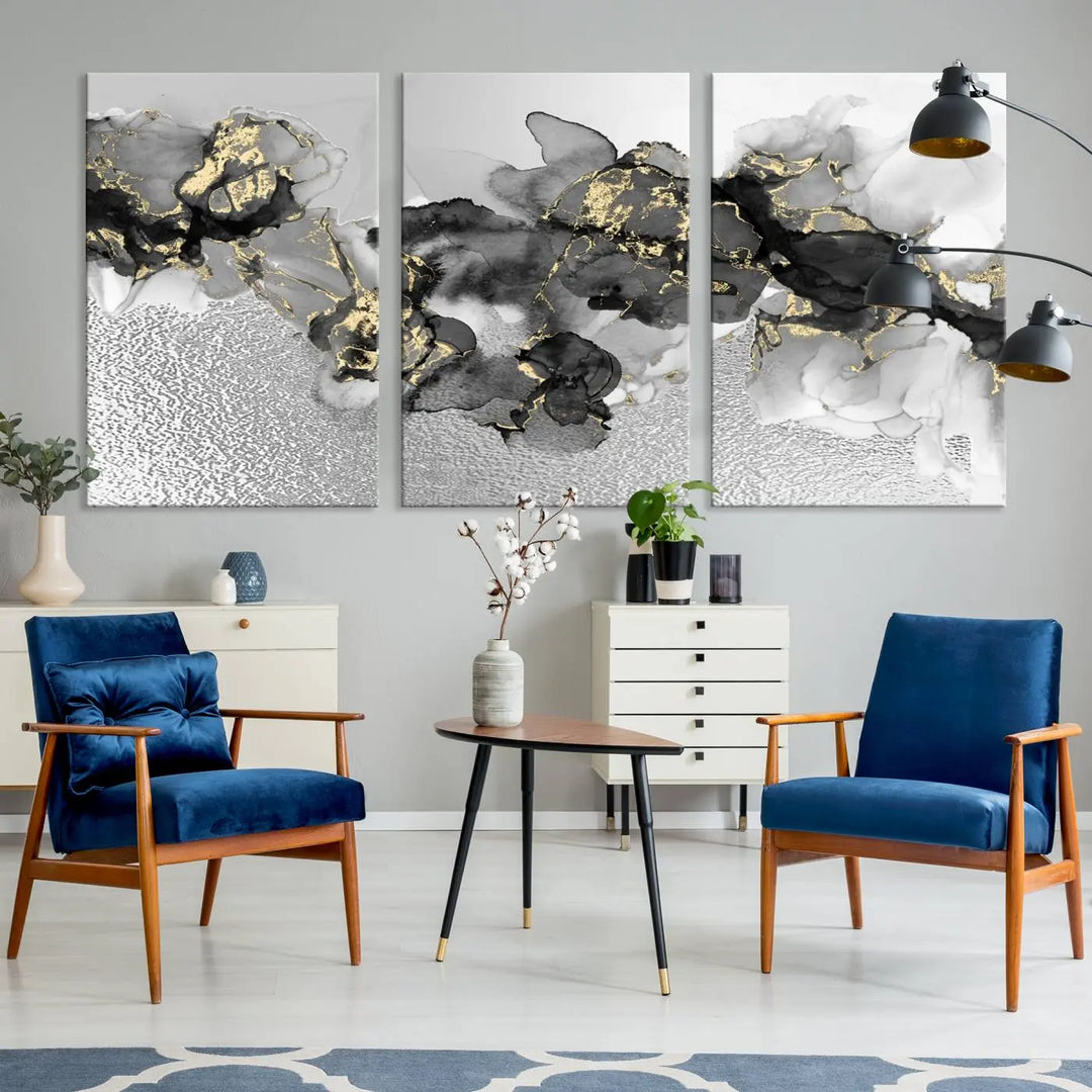 The Gray Marble Fluid Effect Wall Art Abstract Canvas Print, featuring black, white, and gold textured patterns, is crafted on museum-quality canvases and finished with a UV-protective coating. This piece adds sophistication to any space.