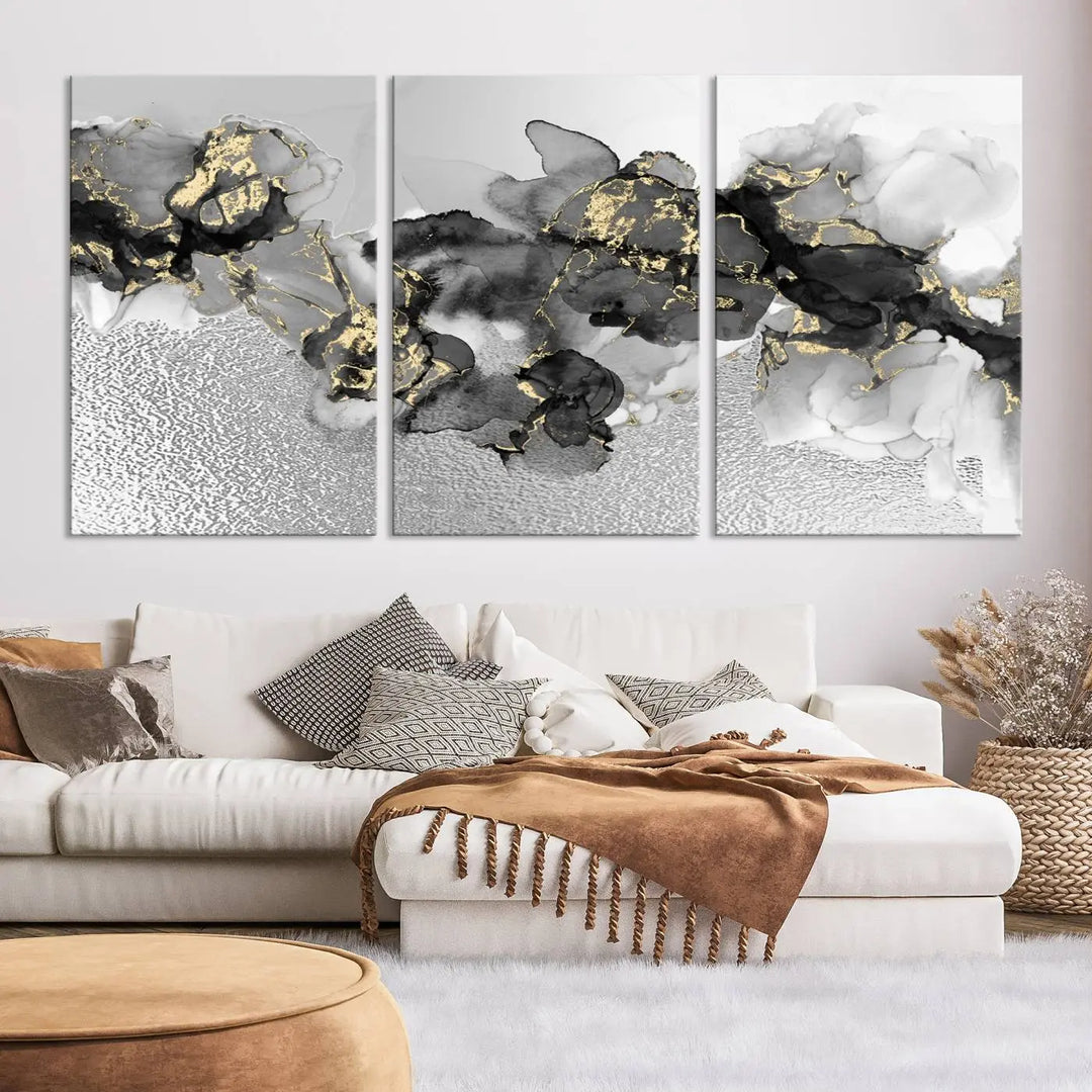 The Gray Marble Fluid Effect Wall Art Abstract Canvas Print, featuring black, white, and gold textured patterns, is crafted on museum-quality canvases and finished with a UV-protective coating. This piece adds sophistication to any space.