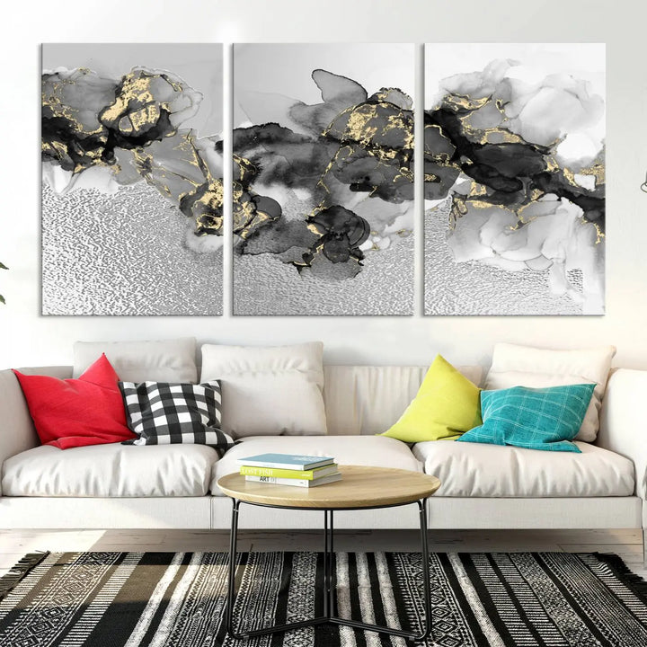 The Gray Marble Fluid Effect Wall Art Abstract Canvas Print, featuring black, white, and gold textured patterns, is crafted on museum-quality canvases and finished with a UV-protective coating. This piece adds sophistication to any space.