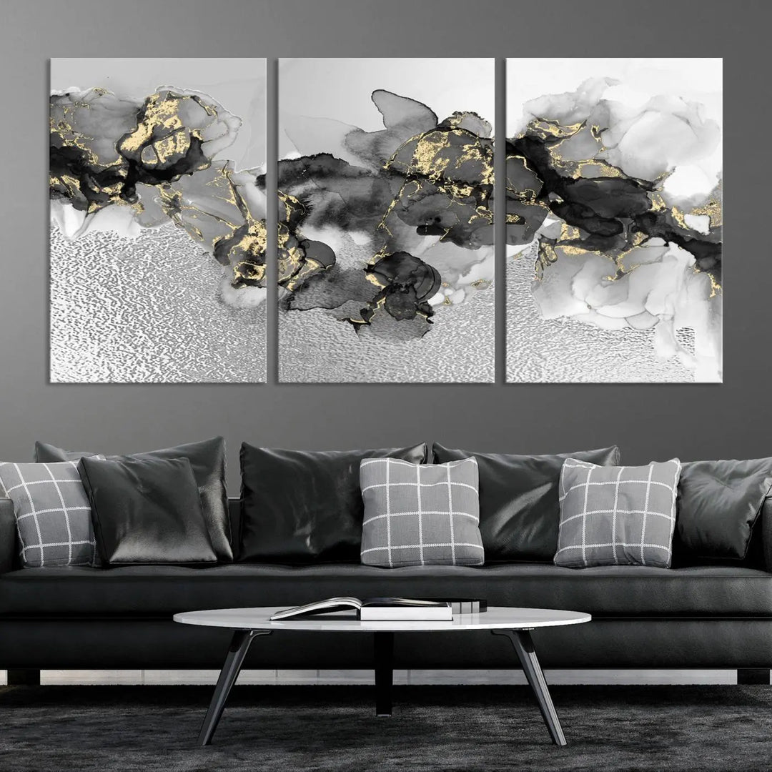 The Gray Marble Fluid Effect Wall Art Abstract Canvas Print, featuring black, white, and gold textured patterns, is crafted on museum-quality canvases and finished with a UV-protective coating. This piece adds sophistication to any space.