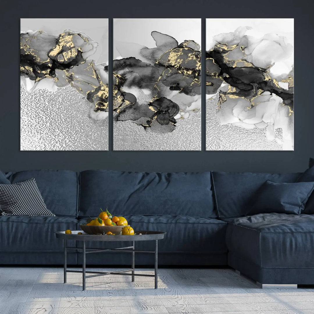 The Gray Marble Fluid Effect Wall Art Abstract Canvas Print, featuring black, white, and gold textured patterns, is crafted on museum-quality canvases and finished with a UV-protective coating. This piece adds sophistication to any space.