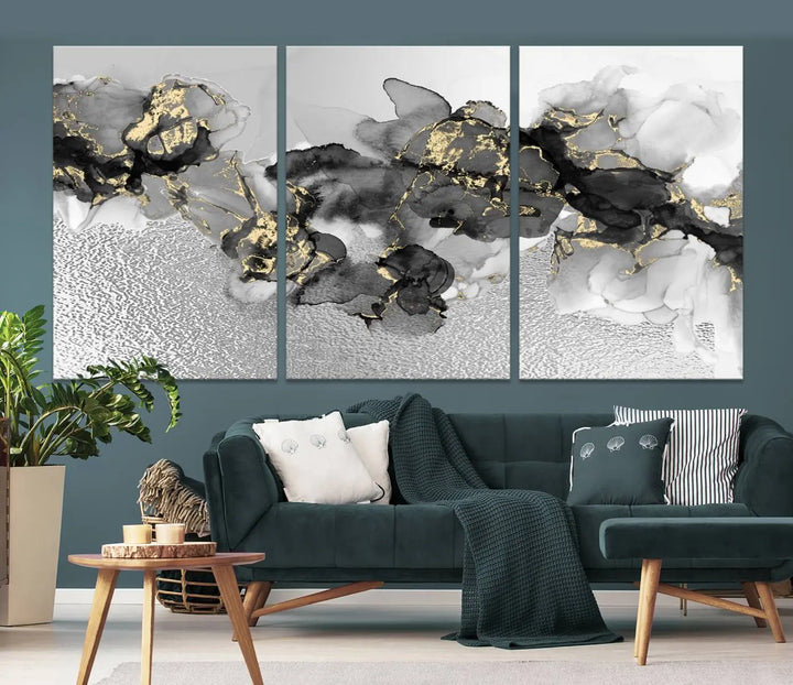 The Gray Marble Fluid Effect Wall Art Abstract Canvas Print, featuring black, white, and gold textured patterns, is crafted on museum-quality canvases and finished with a UV-protective coating. This piece adds sophistication to any space.