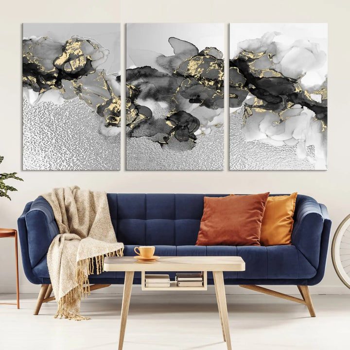 The Gray Marble Fluid Effect Wall Art Abstract Canvas Print, featuring black, white, and gold textured patterns, is crafted on museum-quality canvases and finished with a UV-protective coating. This piece adds sophistication to any space.