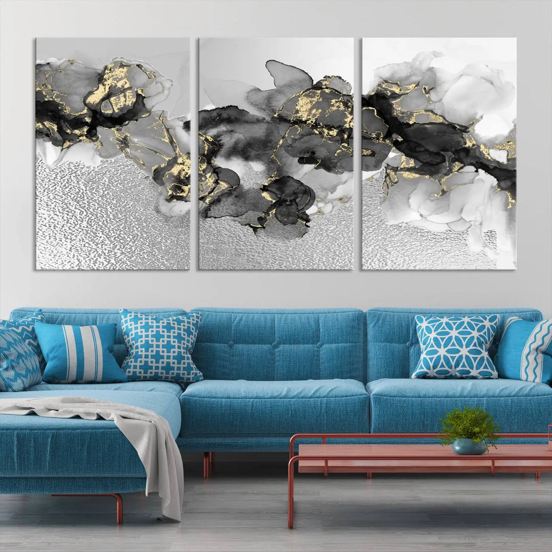 The Gray Marble Fluid Effect Wall Art Abstract Canvas Print, featuring black, white, and gold textured patterns, is crafted on museum-quality canvases and finished with a UV-protective coating. This piece adds sophistication to any space.