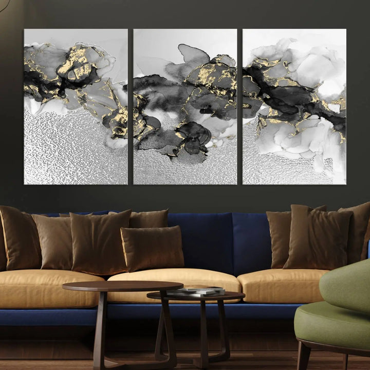 The Gray Marble Fluid Effect Wall Art Abstract Canvas Print, featuring black, white, and gold textured patterns, is crafted on museum-quality canvases and finished with a UV-protective coating. This piece adds sophistication to any space.