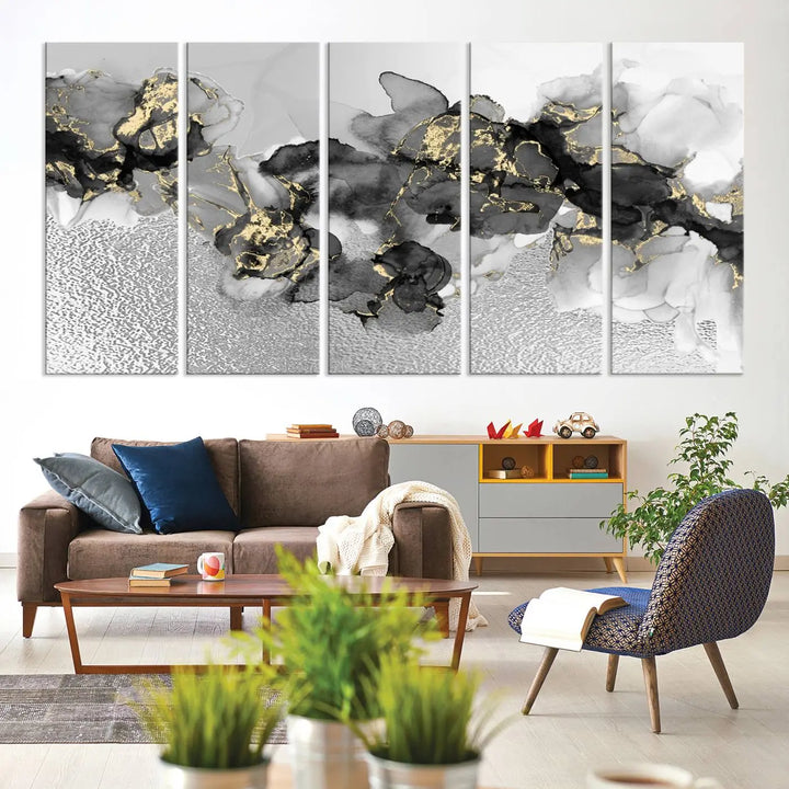 The Gray Marble Fluid Effect Wall Art Abstract Canvas Print, featuring black, white, and gold textured patterns, is crafted on museum-quality canvases and finished with a UV-protective coating. This piece adds sophistication to any space.