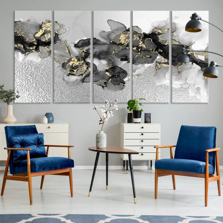 The Gray Marble Fluid Effect Wall Art Abstract Canvas Print, featuring black, white, and gold textured patterns, is crafted on museum-quality canvases and finished with a UV-protective coating. This piece adds sophistication to any space.